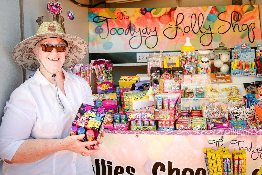Image showing smiling lady in front of a market stall full of sweet treats from the Toodyay Lolly Shoppe.
